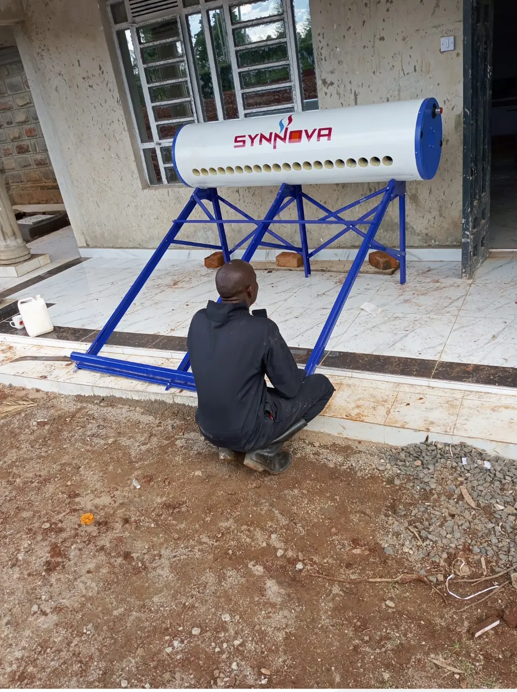 Dema Plumbing technician inspecting a completed solar water heater installation.